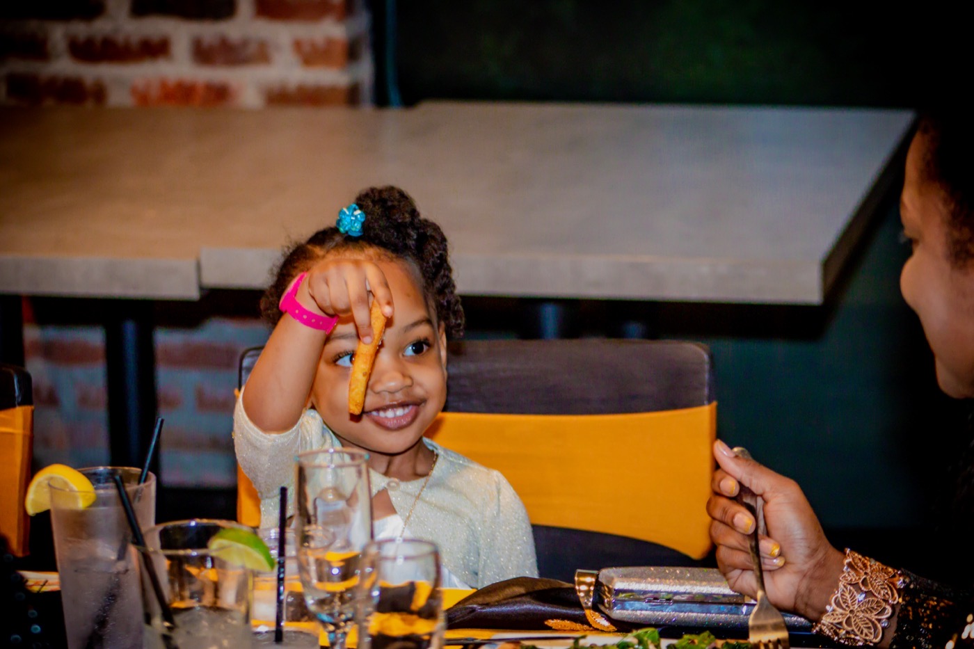 Young guest enjoying a birthday celebration dinner, by TECHINRI AGENCY