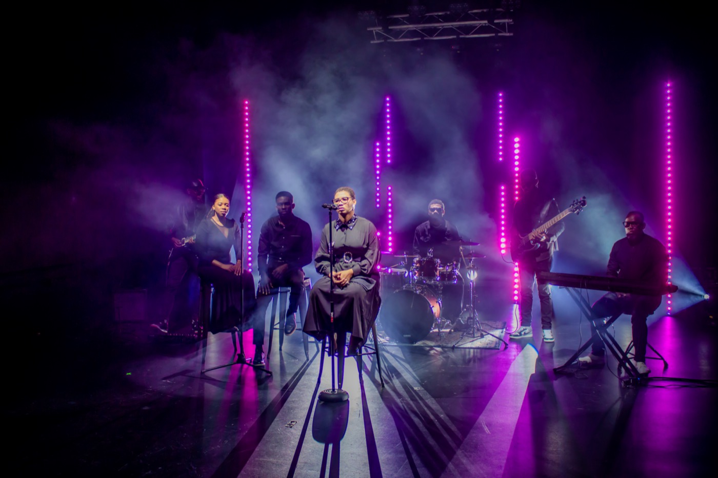 Full band performing on a lit stage during a music video shoot by TECHINRI AGENCY