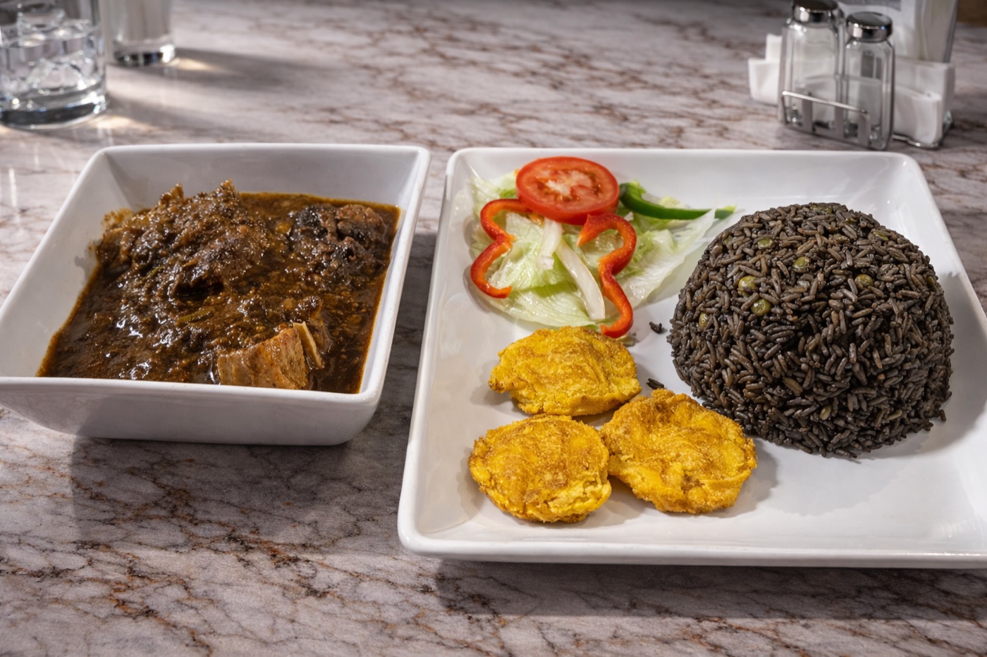 Griot with fried plantains and pikliz at You & I Restaurant